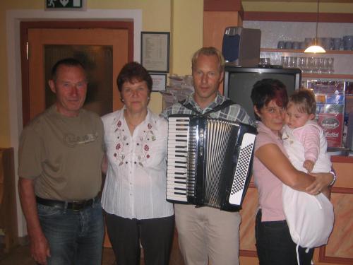 a group of people standing together with an accordion at Alpenpension Elferblick in Neustift im Stubaital