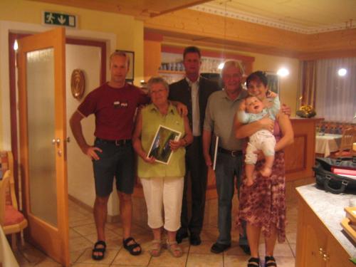 a group of people posing for a picture in a kitchen at Alpenpension Elferblick in Neustift im Stubaital