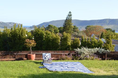 a blanket laying on the grass in a yard at Seabatical in Knysna