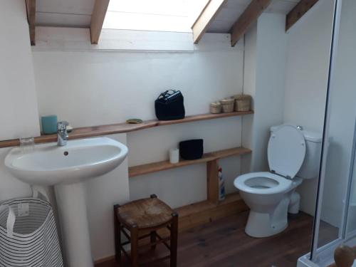 a bathroom with a sink and a toilet at LE PIGEONNIER UTAH BEACH in Sainte-Marie-du-Mont