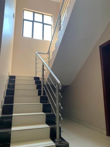 a staircase in a building with a window at Bannerloft Guest house in Gaborone
