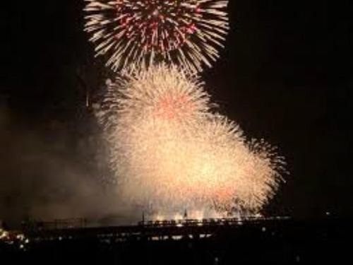 a firework exploding in the sky at night at Sadie's Home in Waizumi
