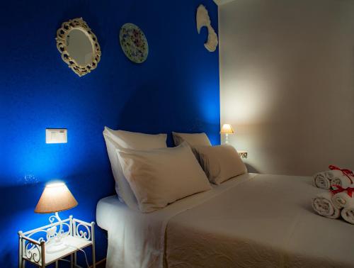 a blue bedroom with a bed and a blue wall at B&B Buonfiglio Cicconcelli - Terrazza panoramica in Frascati