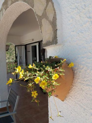 an archway with yellow flowers on a patio at Villa Bello Horizonte regio Denia - Javea in Pedreguer