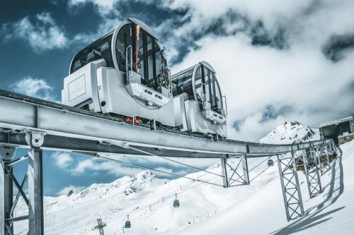 a ski lift on top of a snow covered mountain at Tschuggen Grand Hotel - The Leading Hotels of the World in Arosa