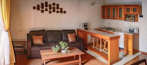 a living room with a couch and a kitchen at Hostal de La Monja in Durango