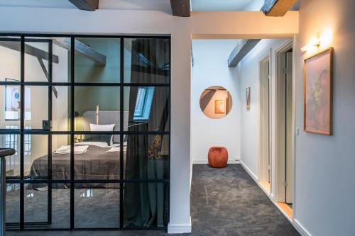 a bedroom with glass doors leading to a bed at The Churchill Penthouse by Daniel&Jacob's in Copenhagen