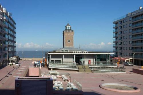 a building with a clock tower on top of it at Apartment with a view and parking in Knokke-Heist