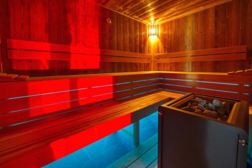 an empty sauna with red and blue lights in it at Národní dům Podbořany in Podbořany