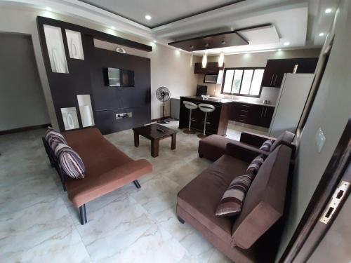 a living room with a couch and a table at WHITE SHARK RESORT in Ponta do Ouro