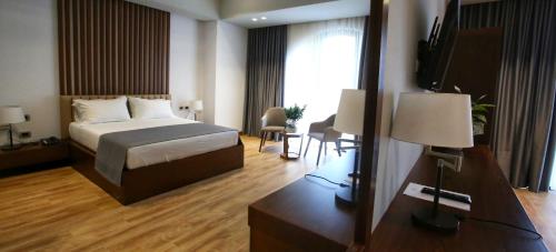 Postel nebo postele na pokoji v ubytování Portik Hotel