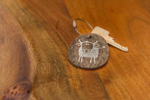 a key chain with a picture of a cow on it at Virgentaler Alp in Prägraten am Großvenediger