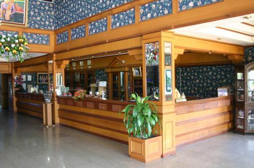 a restaurant with a counter in a building at Sakol Grand Palace in Sakon Nakhon