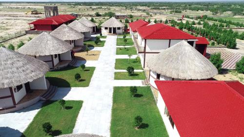an aerial view of a village with thatched roofs at Rann Resort Dholavira in Dholovira