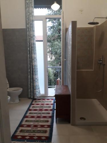 a bathroom with a shower and a tub and a window at Villa Sapi in Arcisate