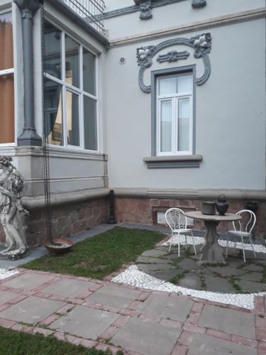 a patio with a table and chairs in front of a house at Villa Sapi in Arcisate