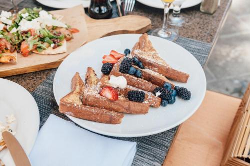 a plate of toast and fruit on a table at Westlake Village Inn in Westlake Village
