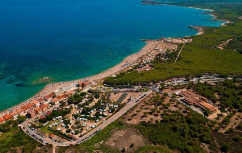 an aerial view of a resort next to the ocean at Hotel Petri Marini in Aglientu