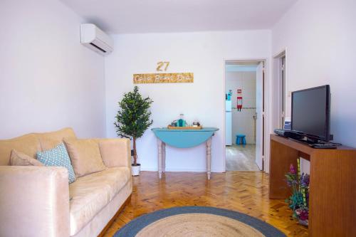 a living room with a couch and a christmas tree at Casa Bom Dia 27 in Sintra