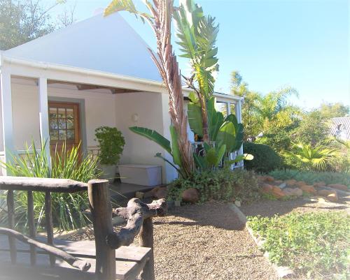 a small white house with plants in front of it at Swellendam Country Lodge - Guest House - B&B in Swellendam