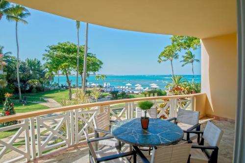 a balcony with a table and chairs and the ocean at Velero Beach Resort in Cabarete