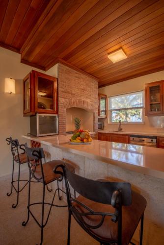 a kitchen with a counter and some chairs in it at Velero Beach Resort in Cabarete