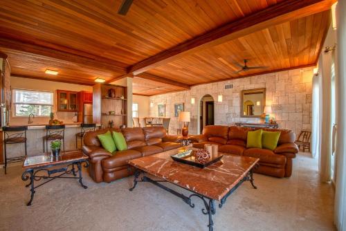 a living room with leather couches and a table at Velero Beach Resort in Cabarete