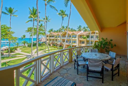 a balcony with a table and chairs and a view of the ocean at Velero Beach Resort in Cabarete