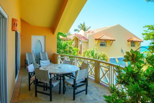a balcony with a table and chairs at Velero Beach Resort in Cabarete