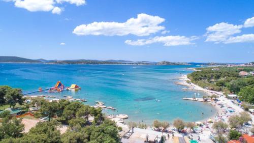 a view of a beach with people in the water at Refresh Boutique Apartments in Vodice