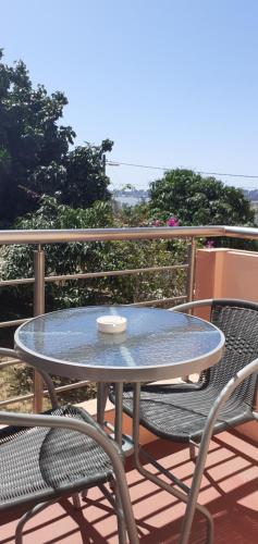 a table and two chairs on a balcony with a table at Wonna Bay Vila Lodge-Catembe in Maputo