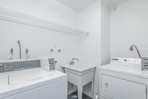 a white bathroom with two sinks and a sink at GetAways at Turtle Reef Club in Jensen Beach