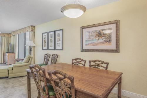 a dining room with a wooden table and chairs at GetAways at Turtle Reef Club in Jensen Beach