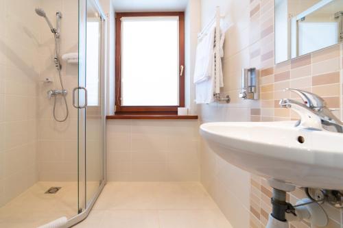 a bathroom with a sink and a shower at Rasos Vila in Palanga