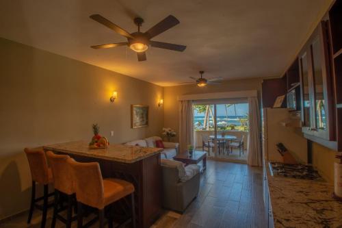 a kitchen and living room with a ceiling fan at Velero Beach Resort in Cabarete