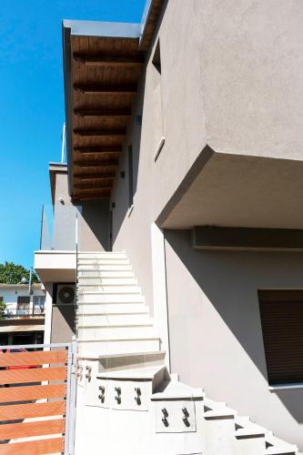 a building with stairs on the side of it at 19.40 Luxury Guesthouse in Kalpákion
