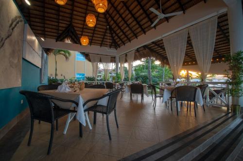 
people sitting at tables in a restaurant at Velero Beach Resort in Cabarete
