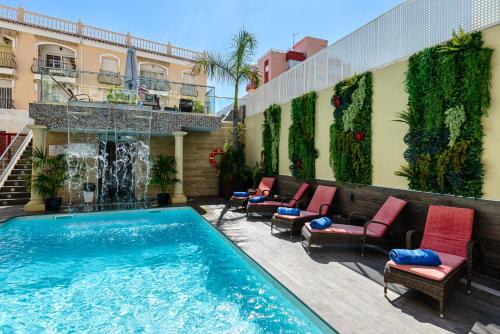 a swimming pool on the side of a building at Moon Dreams Torremolinos in Torremolinos