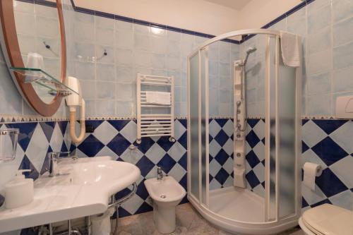 a bathroom with a shower and a sink and a toilet at Hotel Villa Elda in Assisi