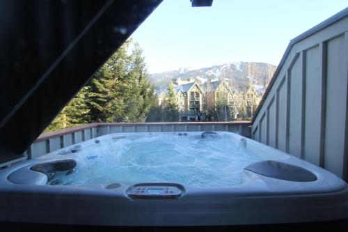 a jacuzzi tub on the deck of a house at Sunpath Condos by Whistler Retreats in Whistler