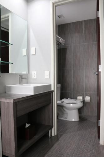 a bathroom with a sink and a toilet at Casa Inn Galerias Celaya in Celaya