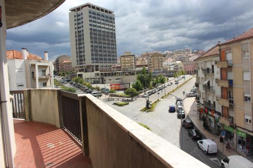 a view from a balcony of a city street with buildings at Viriato Central House in Viseu
