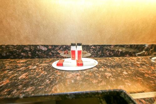 a plate with a drink on top of a table at Howard Johnson by Wyndham Winnipeg West in Winnipeg