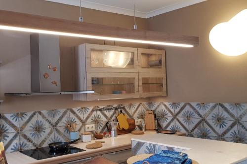 a kitchen with wooden cabinets and a counter top at Studio Azul in Olhão