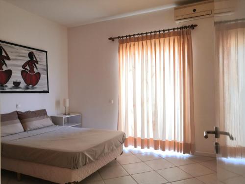 a bedroom with a bed and a large window at Sal Service Santana double bedrooms sea view angulo in Santa Maria