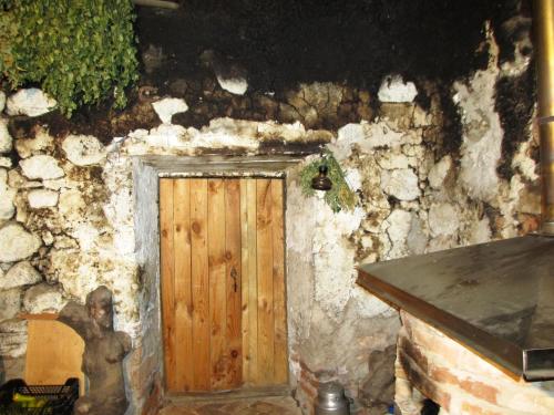 a wooden door in a stone wall at Pilkalnes muiža in Nereta