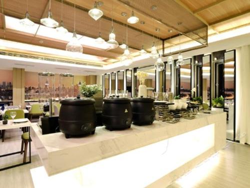 a bar with three large sinks in a restaurant at Atour Hotel Wuhan Changqing Road Branch in Wuhan