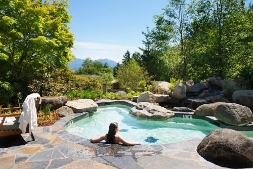 a woman sitting in a pool in a backyard at Skamania Lodge in Stevenson