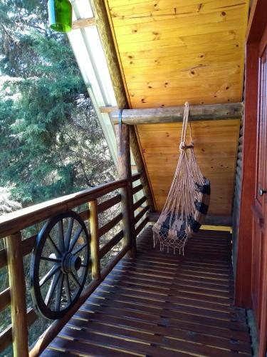 a porch of a cabin with a hammock at CHALÉ ESTÂNCIA OURO VERDE in Lages