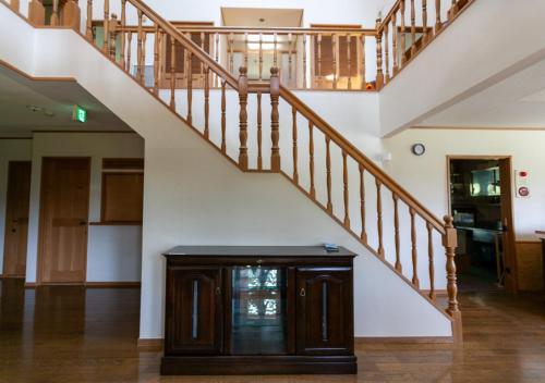 a staircase with a wooden cabinet in a house at Niseko Ski Lodge - Higashiyama in Niseko